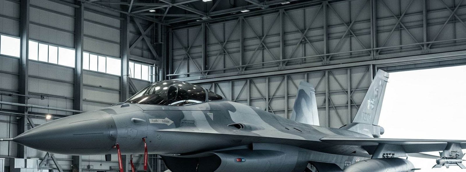 Fighter jet in a maintenance hangar